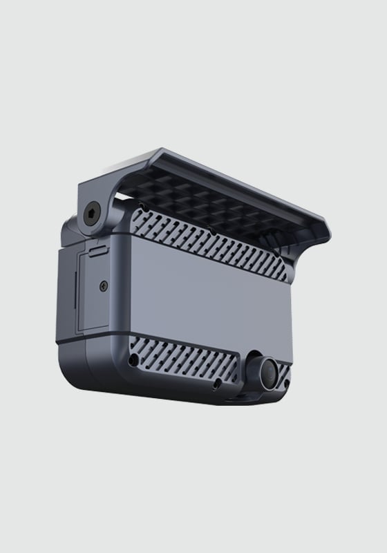 3D rendered gray and black electronic device with ventilation grills and circular ports against white background